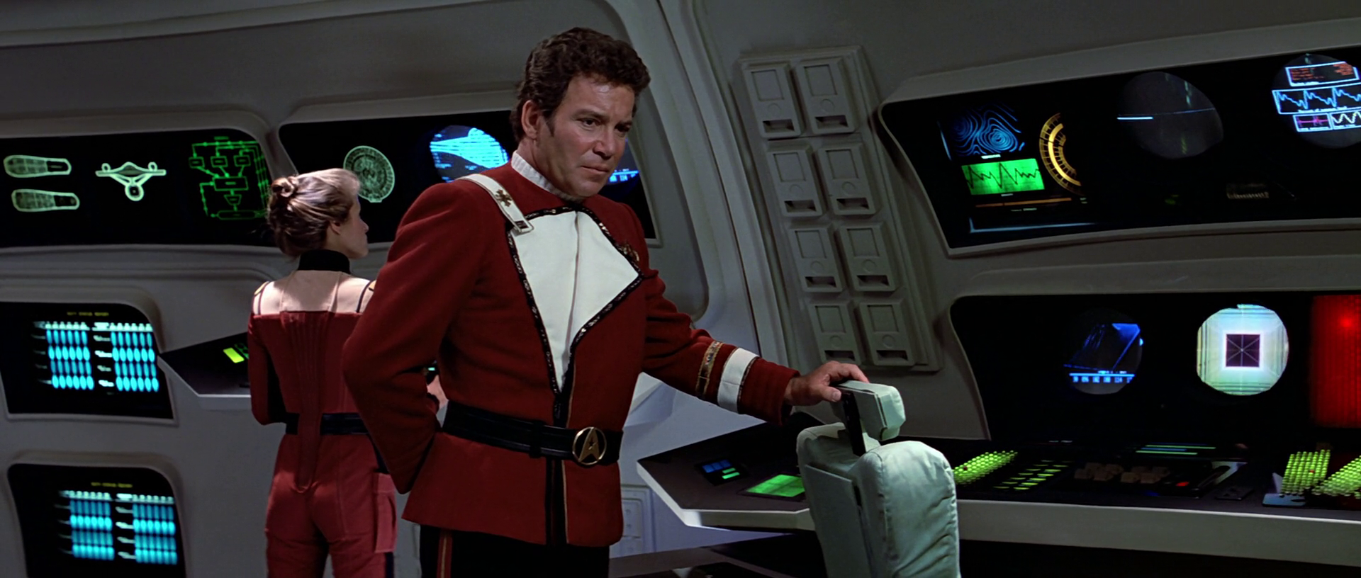 Kirk on the bridge of the Enterprise touching spoks emptyy chair